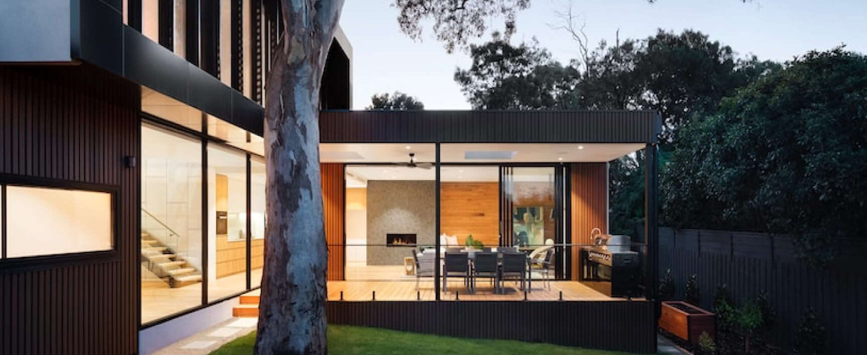 Modern house with a large outdoor deck and patio area